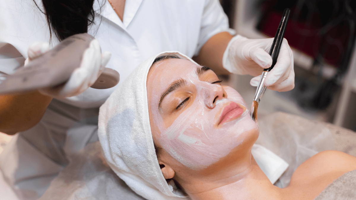 Esthetician applying a chemical peel to a woman's face at Elite Med Spa Berwyn